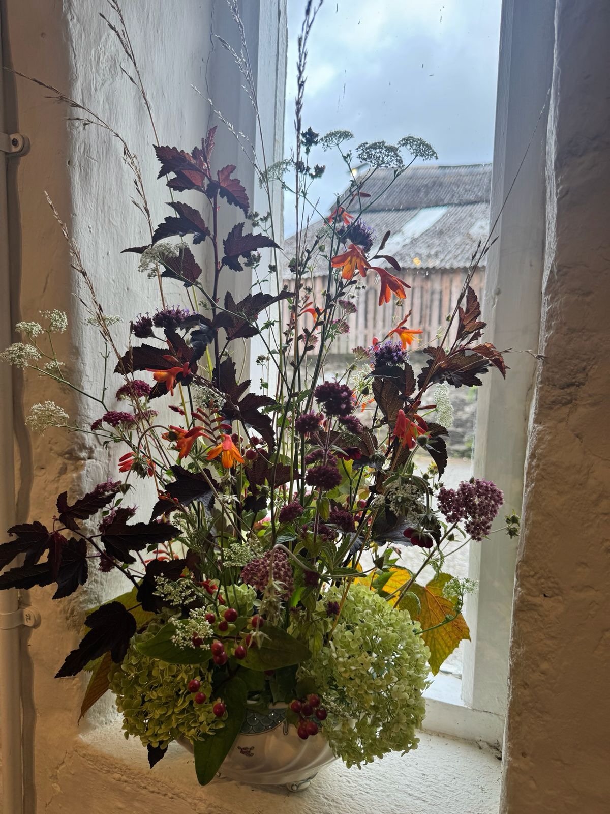 Seasonal flowers arranged in the garden window