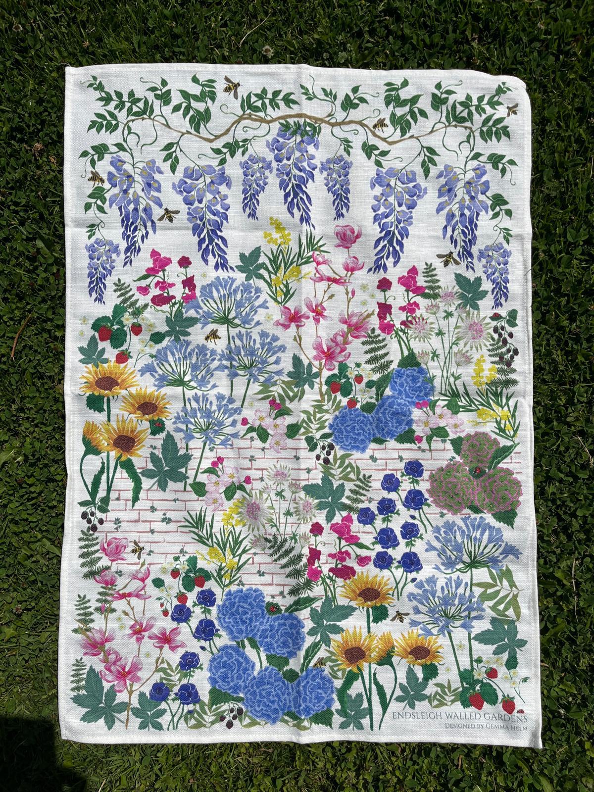 The Endsleigh Walled Gardens tea towel designed by Gemma Helm, with wisteria, flowers and bees